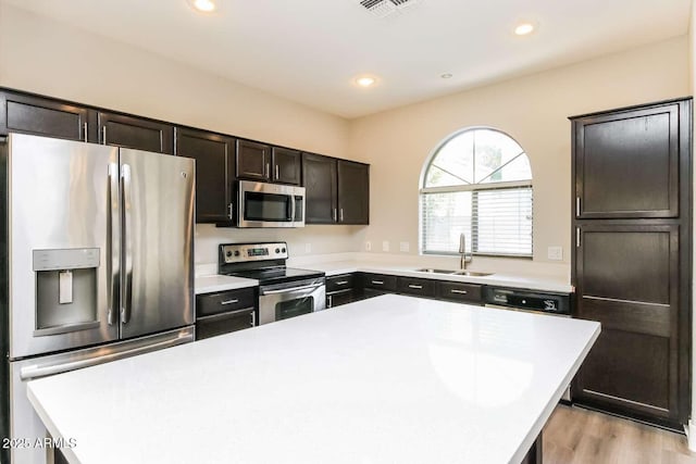 5329 E Harmony Ave, Mesa, AZ 85206 - kitchen featuring appliances with stainless steel finishes, a sink, a center island, light countertops, and recessed lighting