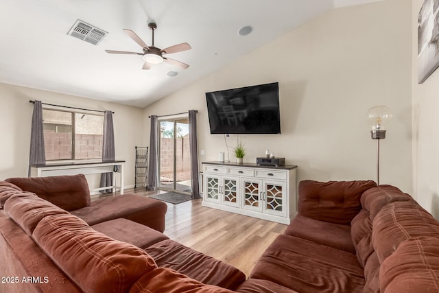 living area featuring lofted ceiling, ceiling fan, light wood-type flooring, and visible vents