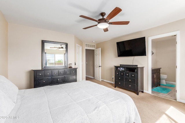 bedroom featuring visible vents, carpet flooring, ceiling fan, ensuite bath, and baseboards