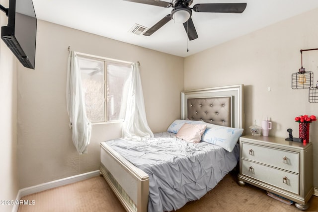 bedroom with light carpet, ceiling fan, visible vents, and baseboards