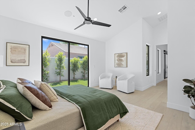 bedroom with access to outside, light wood-style flooring, visible vents, and baseboards