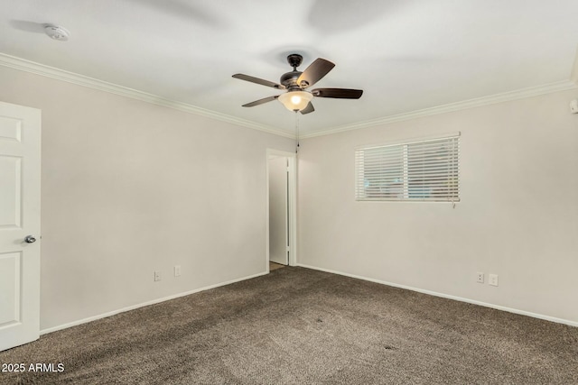 carpeted empty room with crown molding, baseboards, and ceiling fan