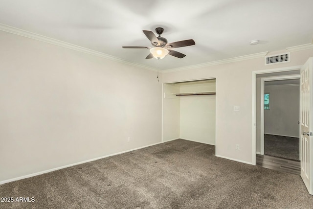 unfurnished bedroom with baseboards, visible vents, ornamental molding, a closet, and carpet flooring