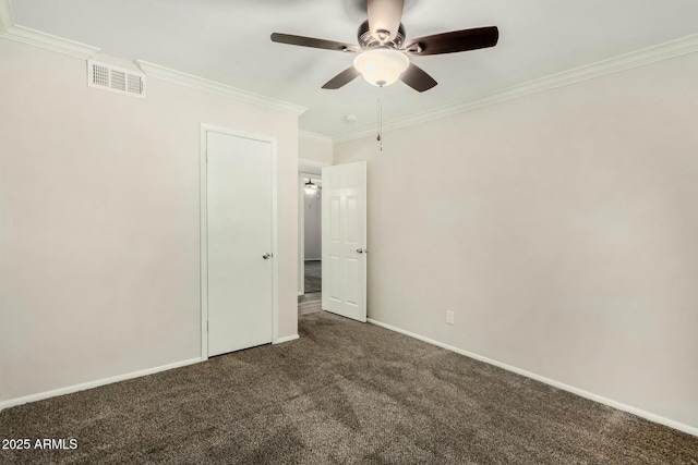 unfurnished bedroom with visible vents, crown molding, baseboards, ceiling fan, and dark carpet