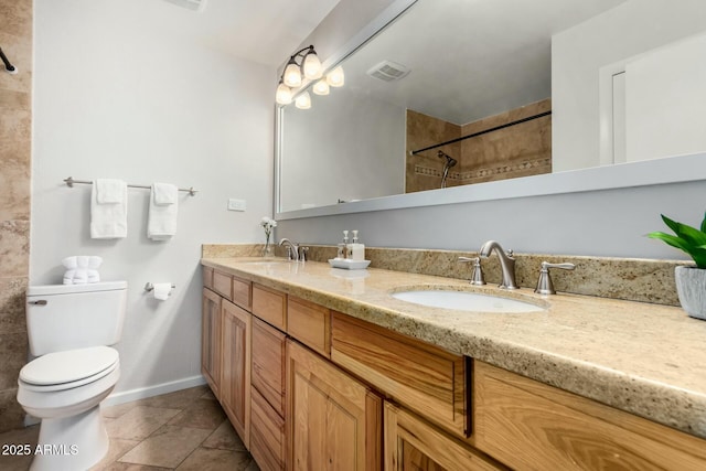 bathroom featuring double vanity, visible vents, toilet, and a sink