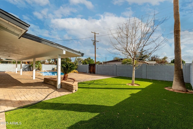 view of yard featuring a patio, a fenced backyard, and a fenced in pool