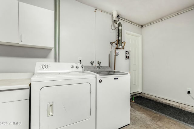 clothes washing area with cabinet space, gas water heater, and washer and dryer