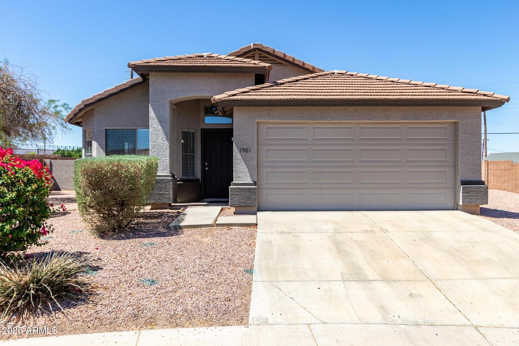 1501 E Sunland Ave, Phoenix, AZ 85040 - ranch-style house featuring stucco siding, an attached garage, concrete driveway, and a tile roof
