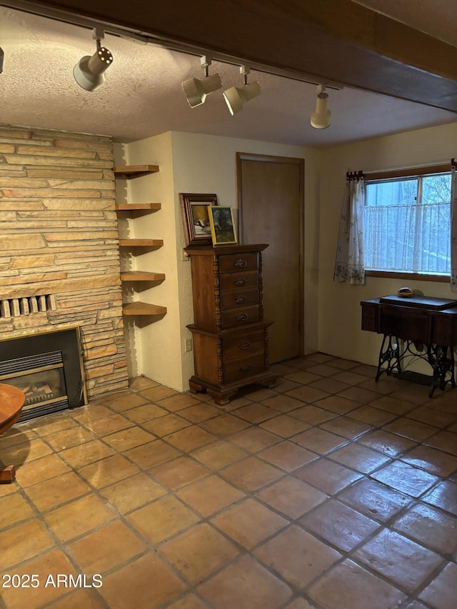 3994 N Mohawk St, Pine, AZ 85544 - living area with track lighting, a glass covered fireplace, and tile patterned flooring