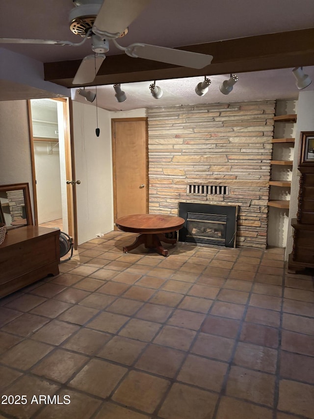 3994 N Mohawk St, Pine, AZ 85544 - unfurnished living room with a ceiling fan, a glass covered fireplace, and tile patterned flooring