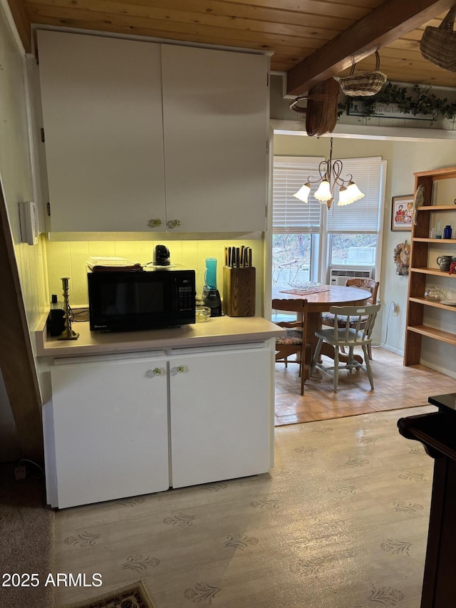 3994 N Mohawk St, Pine, AZ 85544 - kitchen featuring black microwave, wooden ceiling, a chandelier, white cabinets, and light wood-style flooring