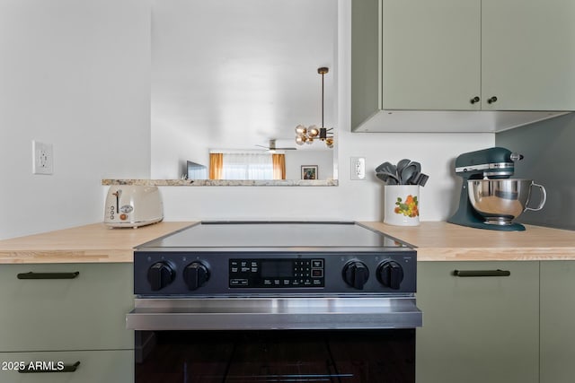 kitchen with electric range oven and green cabinets