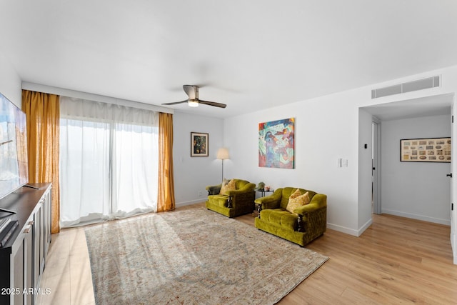 living area featuring ceiling fan and light hardwood / wood-style flooring