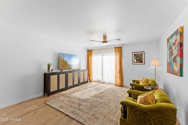 living room featuring ceiling fan and hardwood / wood-style flooring