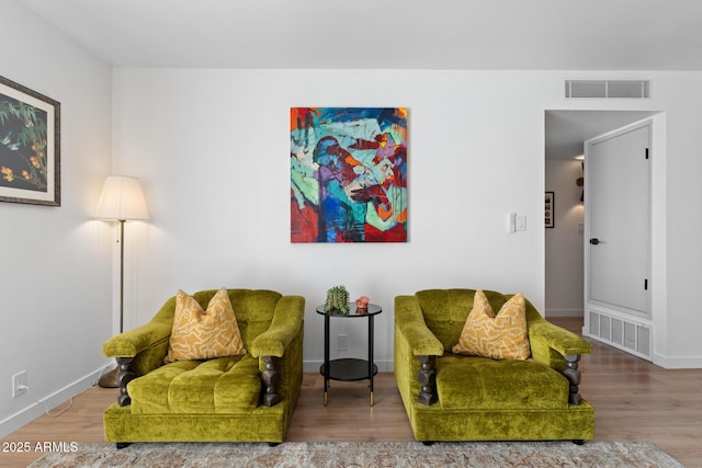 sitting room with hardwood / wood-style flooring