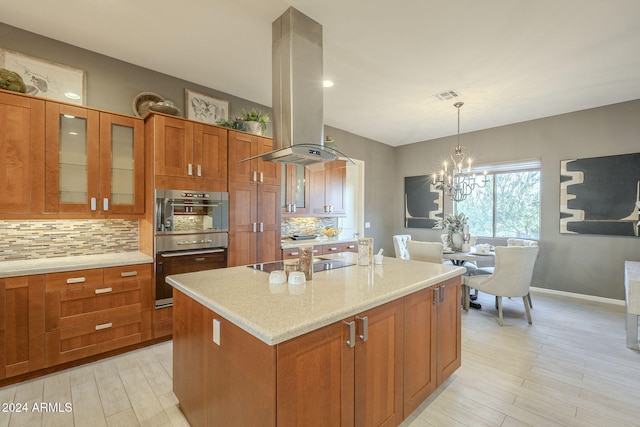 kitchen featuring black electric cooktop, island range hood, a center island, and decorative backsplash