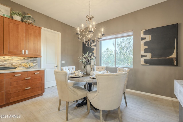 dining room featuring light hardwood / wood-style flooring and a chandelier