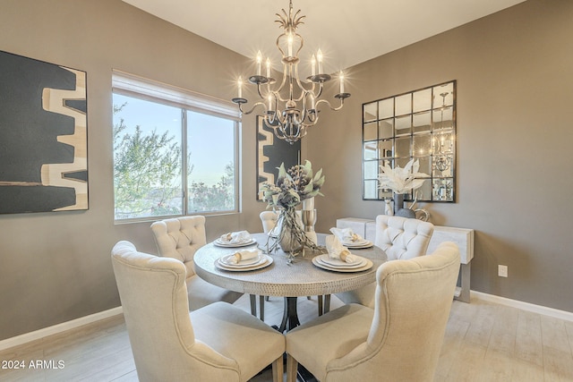 dining space with a chandelier and light wood-type flooring