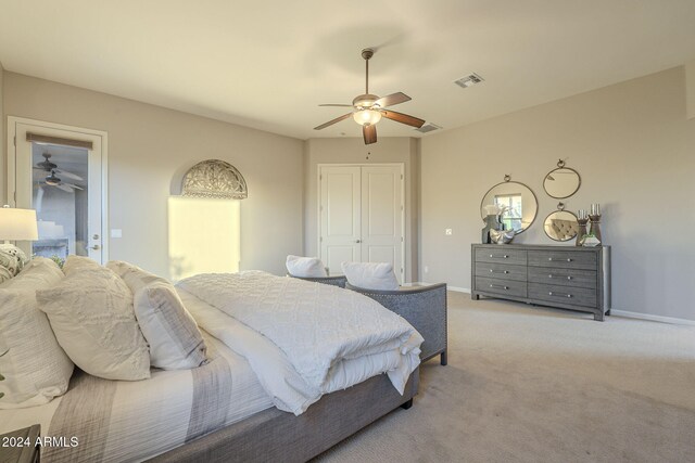 carpeted bedroom featuring a closet and ceiling fan