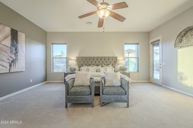 bedroom with ceiling fan, access to exterior, and light carpet