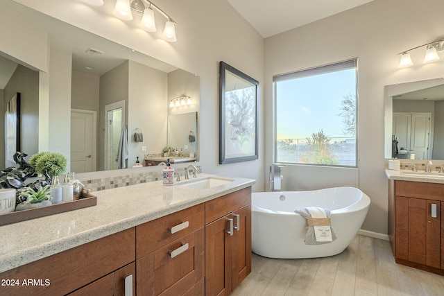 bathroom featuring a tub to relax in and vanity