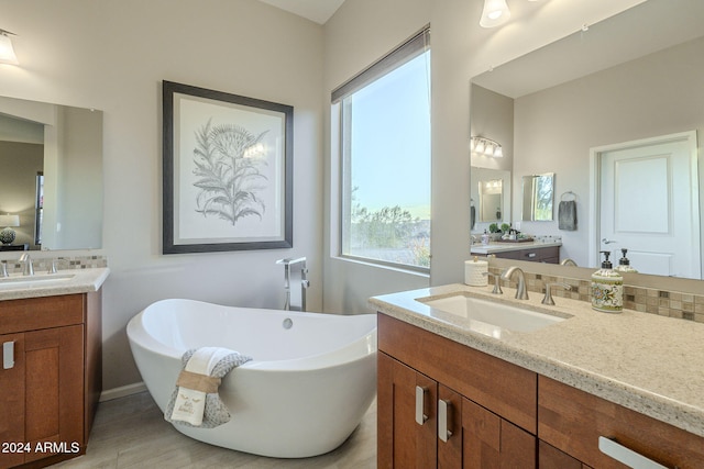 bathroom with vanity and a tub