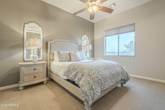 bedroom with ceiling fan and light carpet