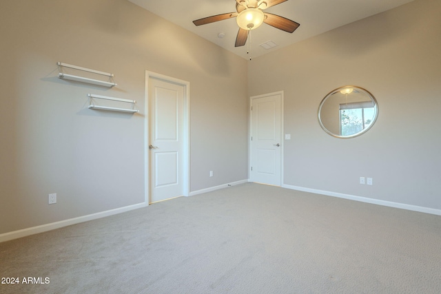 unfurnished bedroom with ceiling fan, carpet floors, and high vaulted ceiling