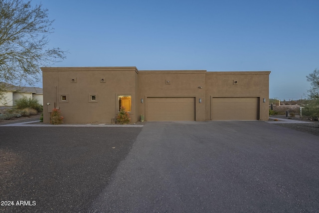 adobe home featuring a garage