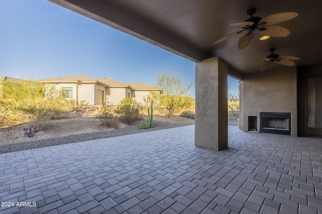 view of patio with ceiling fan and exterior fireplace