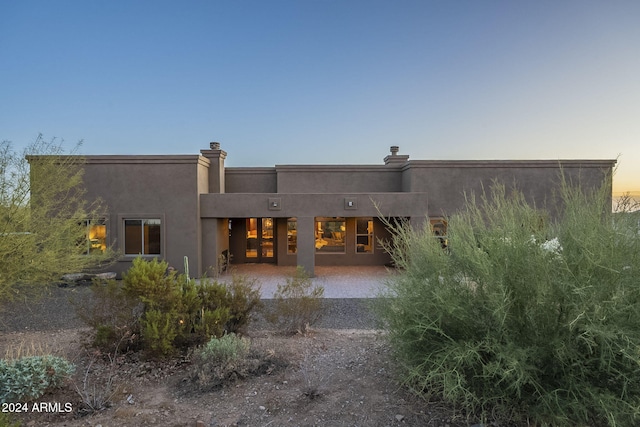 view of back house at dusk