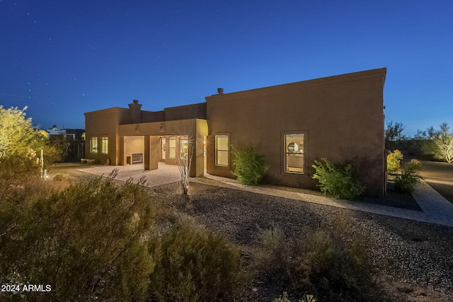 back of property with a patio