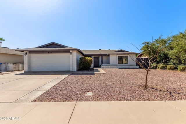 ranch-style house featuring brick siding, driveway, an attached garage, and fence