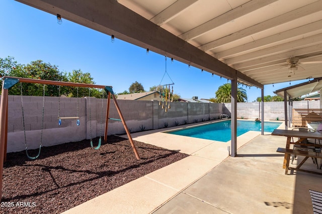 view of pool with a playground, a patio area, a fenced in pool, and a fenced backyard