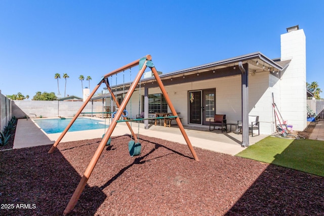 view of play area featuring a fenced in pool, a patio, and a fenced backyard