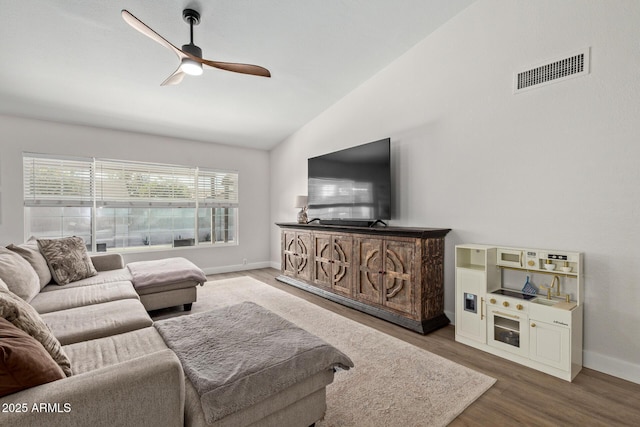 living area with a ceiling fan, wood finished floors, visible vents, baseboards, and lofted ceiling