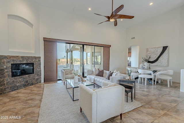 28423 N 139th St, Scottsdale, AZ 85262 - living area with a fireplace, a high ceiling, arched walkways, ceiling fan, and recessed lighting