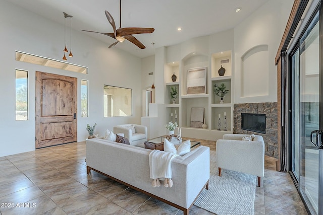 28423 N 139th St, Scottsdale, AZ 85262 - living room featuring a high ceiling, a ceiling fan, a fireplace, and built in shelves