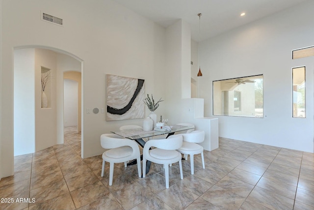 28423 N 139th St, Scottsdale, AZ 85262 - dining space with a high ceiling, a ceiling fan, arched walkways, and visible vents