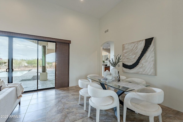28423 N 139th St, Scottsdale, AZ 85262 - dining area with visible vents, arched walkways, and a towering ceiling