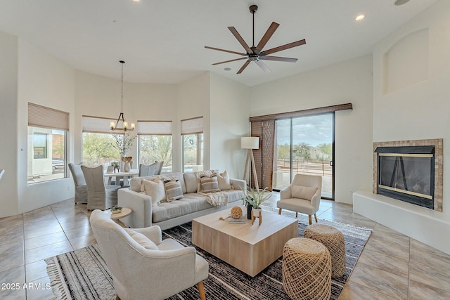 28423 N 139th St, Scottsdale, AZ 85262 - living area featuring a high ceiling, a glass covered fireplace, recessed lighting, and light tile patterned floors