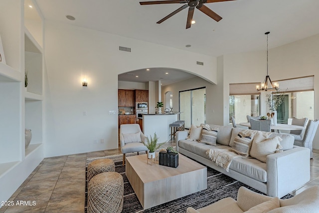 28423 N 139th St, Scottsdale, AZ 85262 - living room with ceiling fan with notable chandelier, visible vents, arched walkways, and recessed lighting