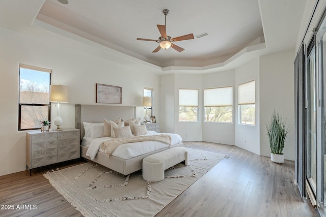 28423 N 139th St, Scottsdale, AZ 85262 - bedroom featuring a tray ceiling, multiple windows, and wood finished floors