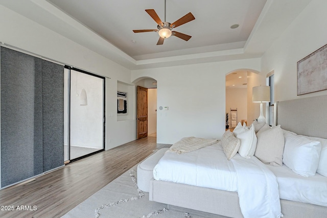 28423 N 139th St, Scottsdale, AZ 85262 - bedroom with a ceiling fan, wood finished floors, arched walkways, and a raised ceiling