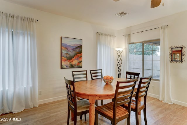 dining space featuring visible vents, baseboards, and light wood-style flooring