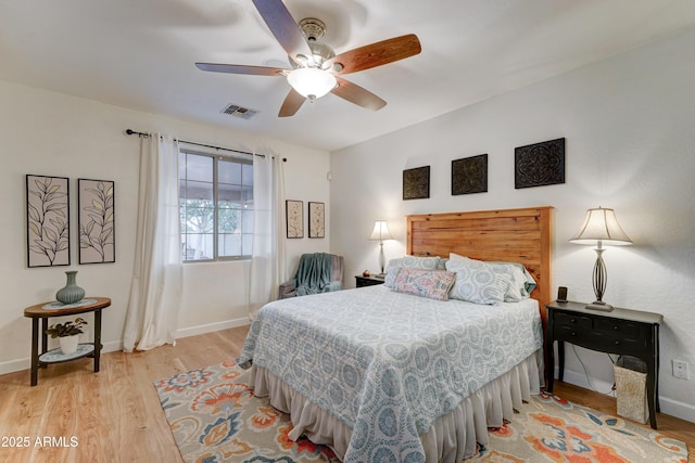 bedroom with ceiling fan, baseboards, visible vents, and light wood-type flooring