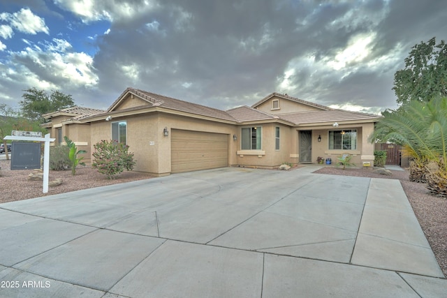 ranch-style house featuring fence, a tile roof, stucco siding, a garage, and driveway