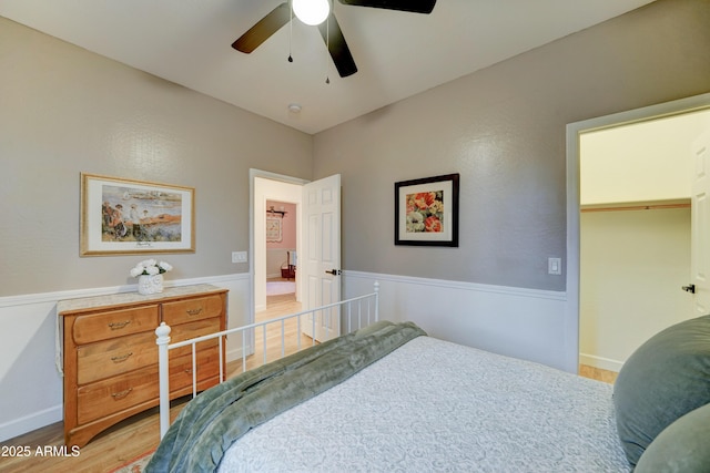 bedroom with light wood-type flooring, a closet, and ceiling fan