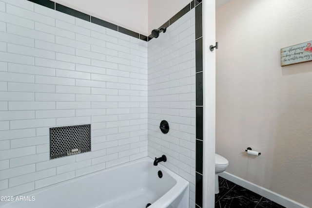 full bathroom with bathtub / shower combination, toilet, baseboards, and marble finish floor