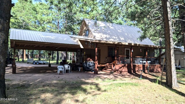 702 Mule Springs Trl, Forest Lakes, AZ 85931 - back of property with metal roof and a carport